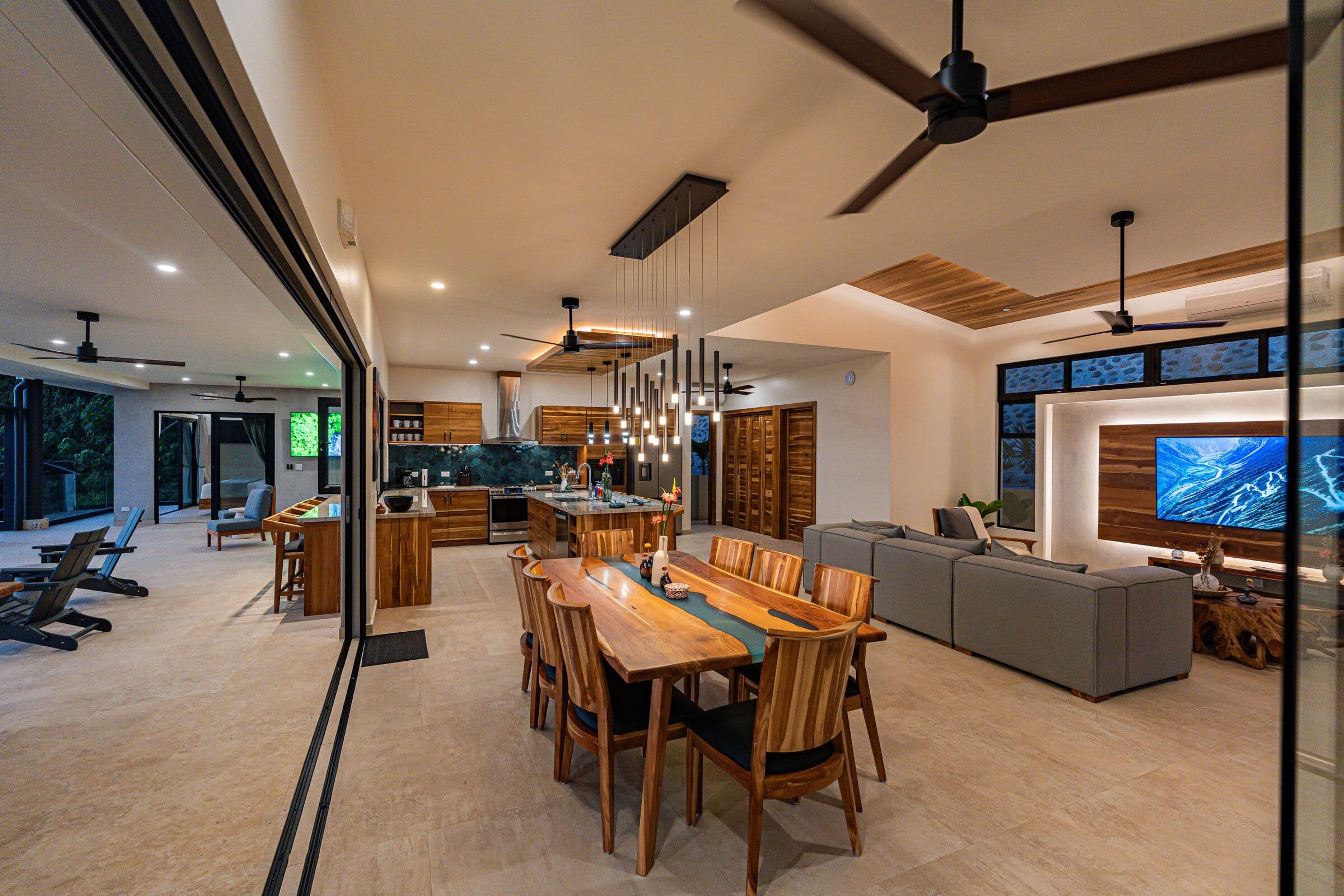 Full open-plan at night: dining, kitchen, TV room