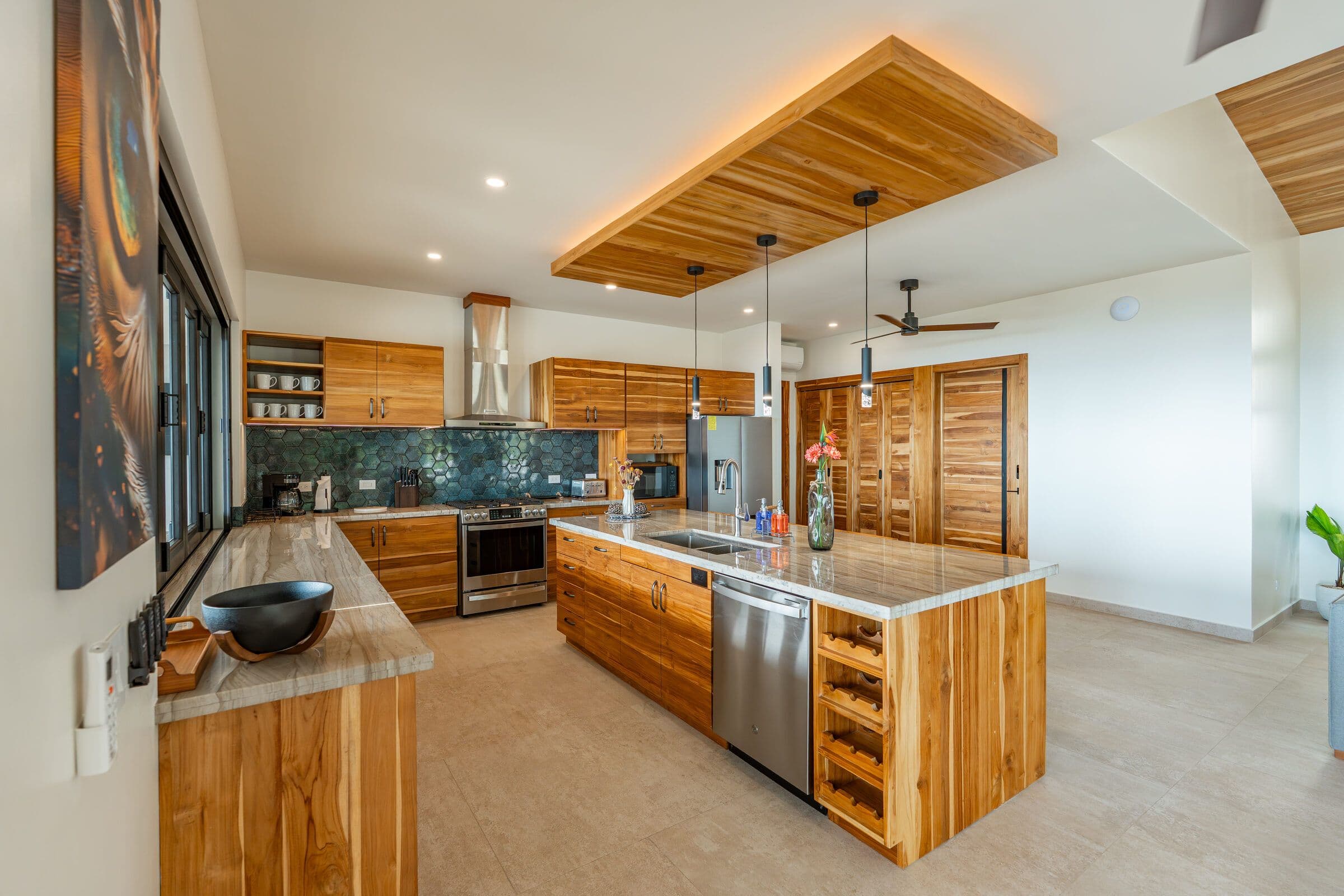 Kitchen with macaw art, wine storage, and island