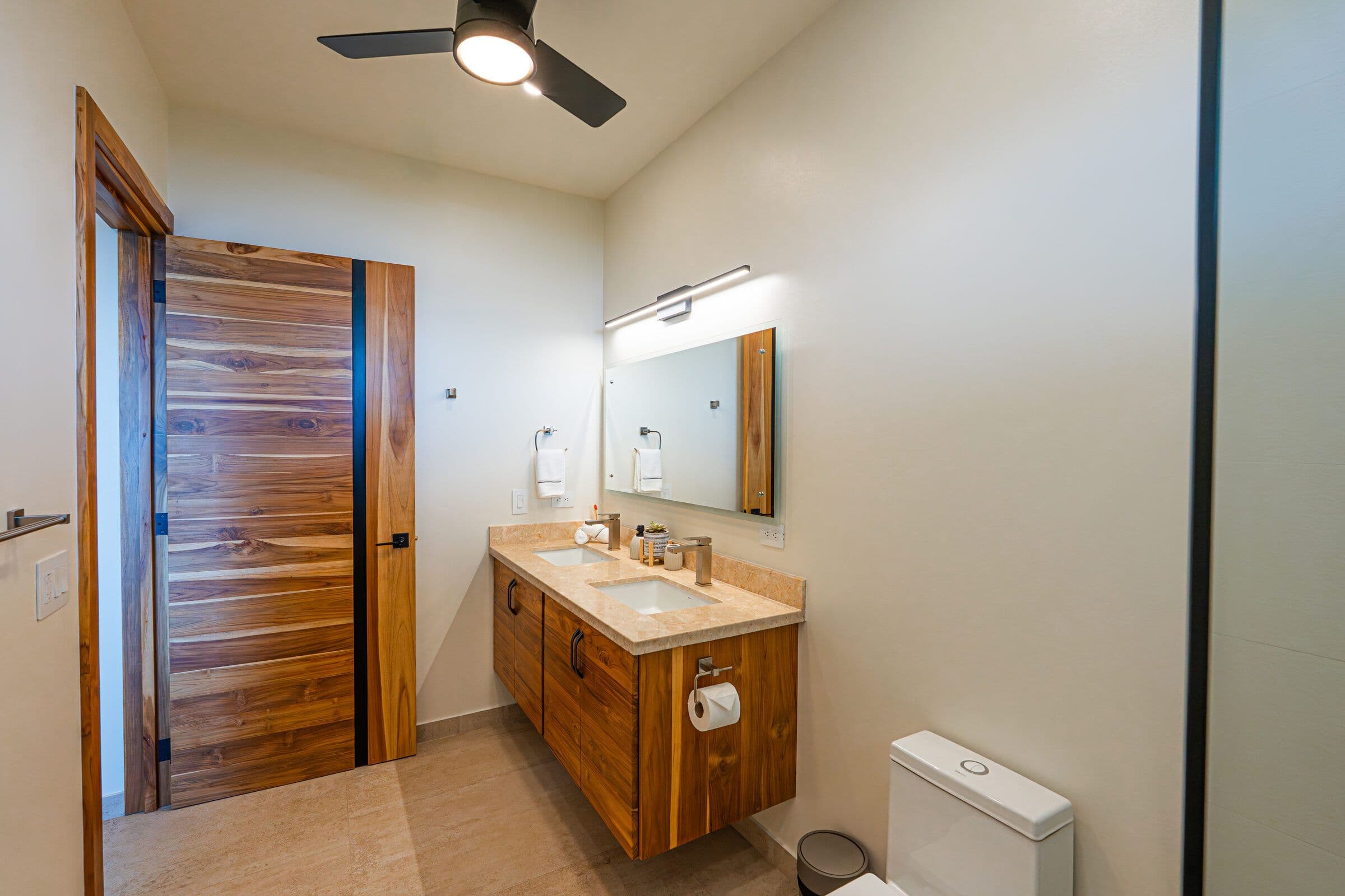 Walk-in rainfall shower with stone accent